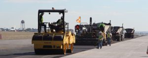 Sakai double drum high frequency vibratory asphalt roller on an airport paving job.