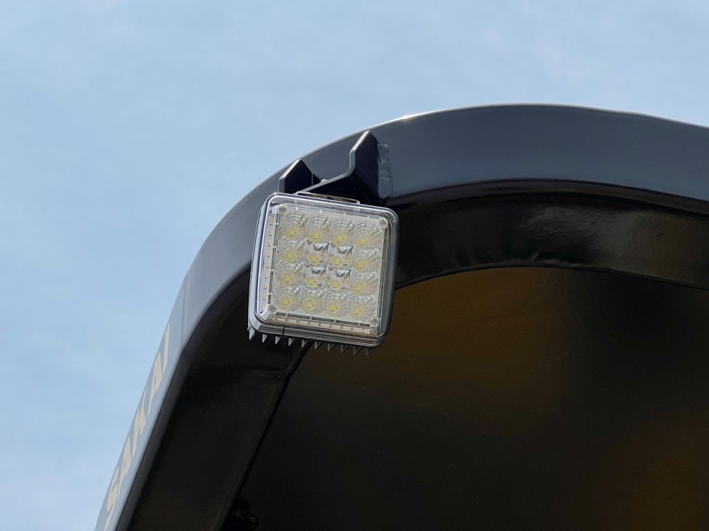 Close up of optional ROPS mounted LED light assembly for the SAKAI R2H-4 3 wheel asphalt compactor.