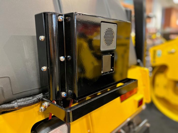 Guardman personnel and equipment proximity and automatic emergency braking millimeter wave radar unit as seen on a Sakai SW504G 51" 4.5 ton asphalt roller.