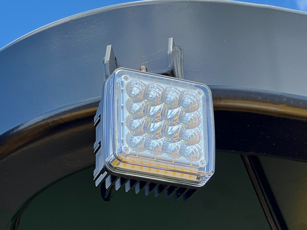 Close up of LED work light assemblies and ROPS mounts on a SAKAI SW654 asphalt roller.