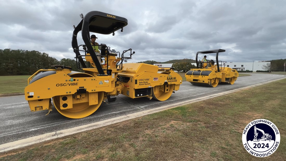 Two SAKAI SW884ND Guardman asphalt rollers in echelon rolling pattern formation with Heavy Equipment Guide Canada 2024 Top Introduction logo.