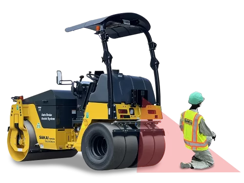 Rear angle view of a SAKAI TW504G Guardman combination drum tire asphalt roller with detection beam and dummy construction worker.