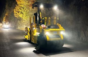 A GW754 PTR or pneumatic tire roller working on a night paving job site and utilizing its optional LED work lights for illuminating the asphalt mat.