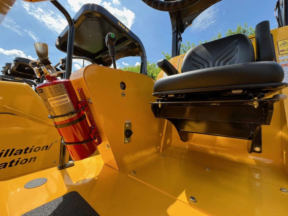 View of operator deck showing easy access to the optional fire extinguisher on a SAKAI SV414 soil compactor.