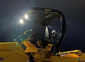 Optional LED work lights illuminated at night on our SW884 asphalt roller provide additional lighting for night paving.