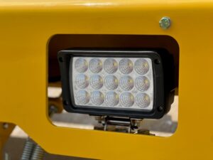 Close up of the front mounted upgraded LED light assembly on the SAKAI SW774 series asphalt roller.