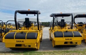 Rear view of two Sakai asphalt rollers comparing the regular height ROPS roll over bar vs the optional low profile ROPS.