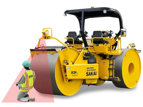 Rear angle view of a SAKAI R2H4 three wheel static asphalt roller equipped with Guardman automatic emergency braking technology positioned in front of a kneeling paving crew worker who is being detected by the 3D LiDAR sensing beam.