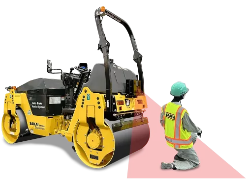 Rear angle view of a SAKAI SW504 double drum vibratory 4.5 ton 51 inch asphalt roller equipped with Guardman automatic emergency braking technology positioned in front of a kneeling paving crew worker who is being detected by the millimeter wave radar sensing beam.
